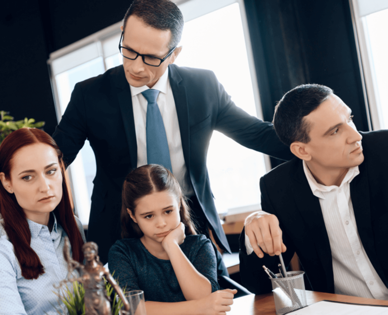 divorce lawyer stands next to parents and child