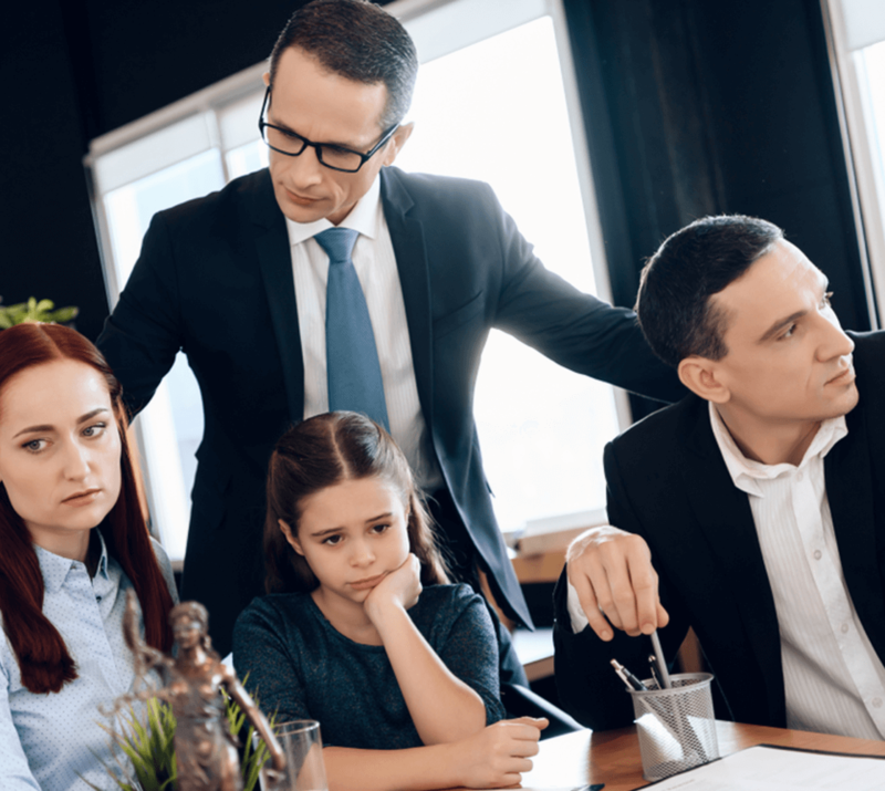 divorce lawyer stands next to parents and child