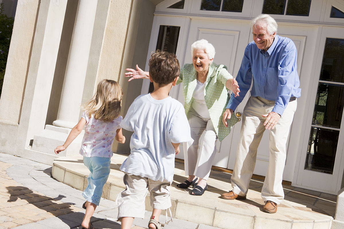 children run into arms of grandparents outside home