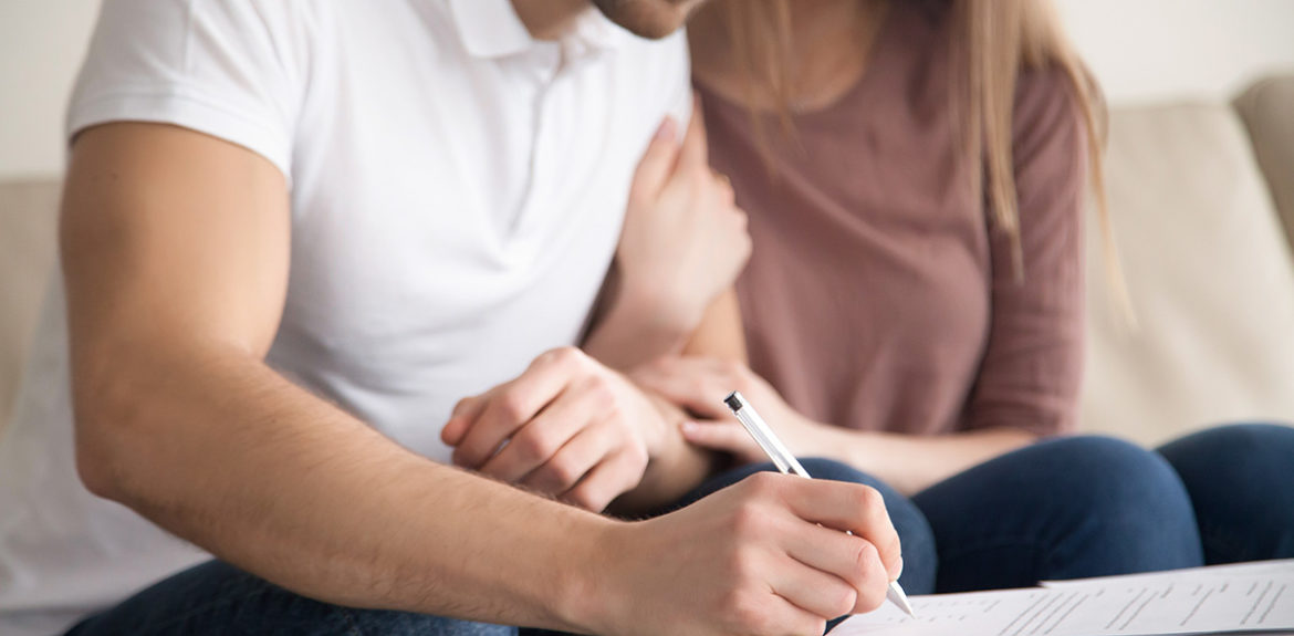 soon-to-be married couple signs a prenuptial agreement before marriage