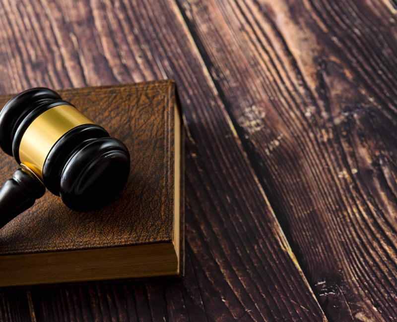 a gavel sits atop a table in a courtroom