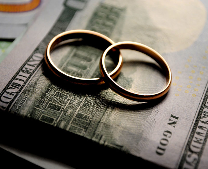 two wedding rings on top of cash