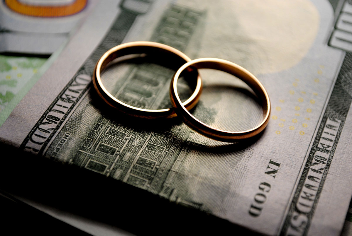 two wedding rings on top of cash