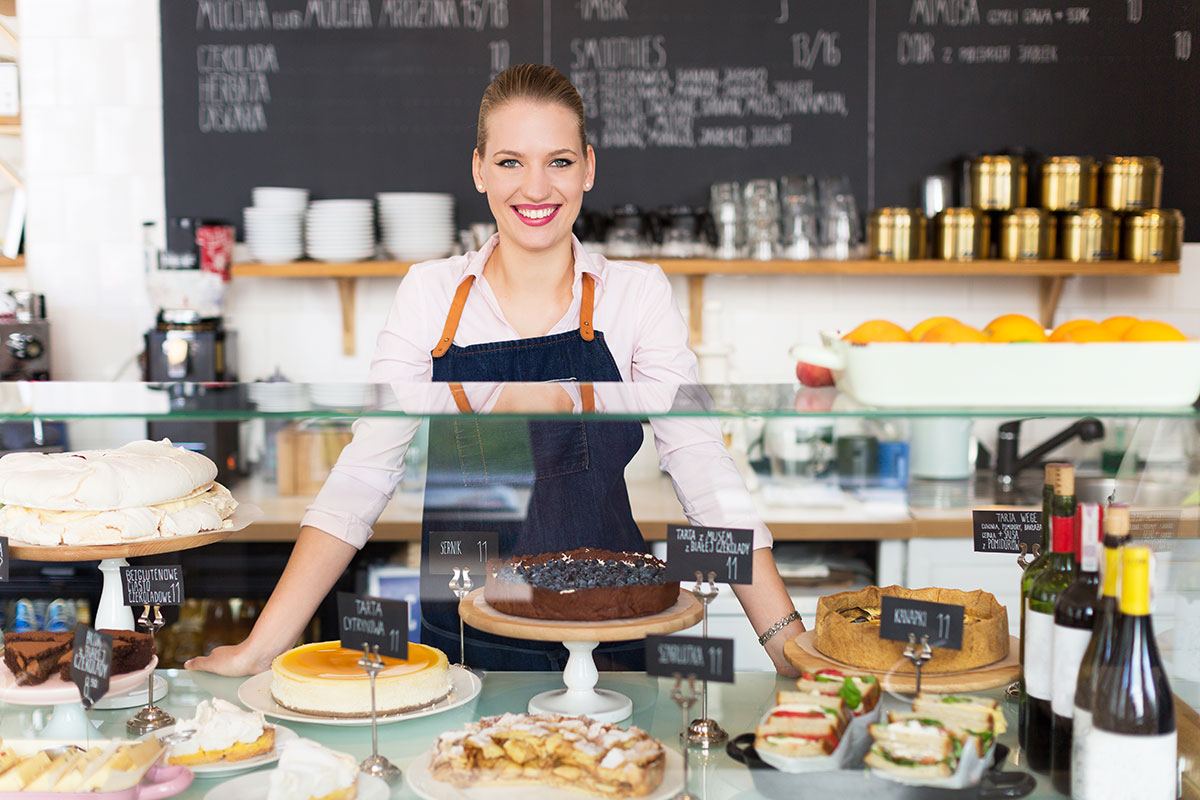 Woman standing behind a dessert counter